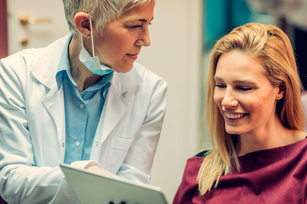 Photo of dentist with a happy patient