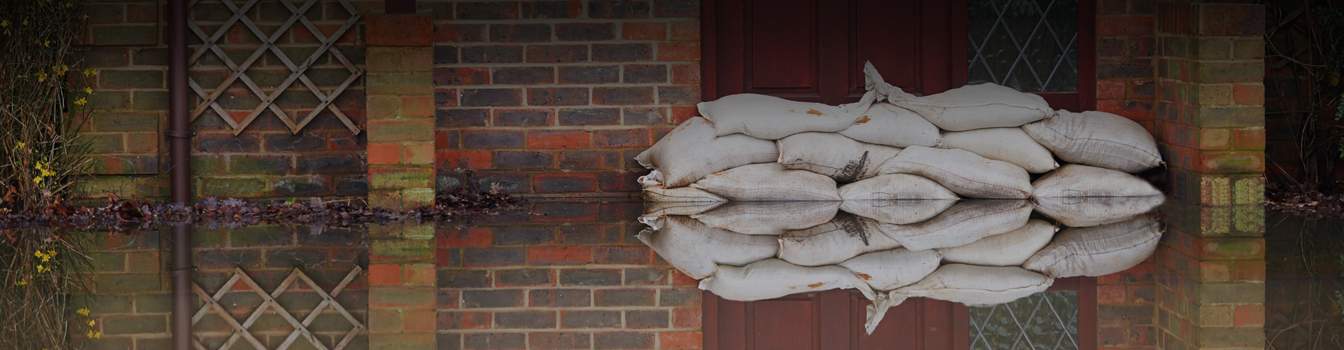 Photo of sandbags and flooding outside of a building