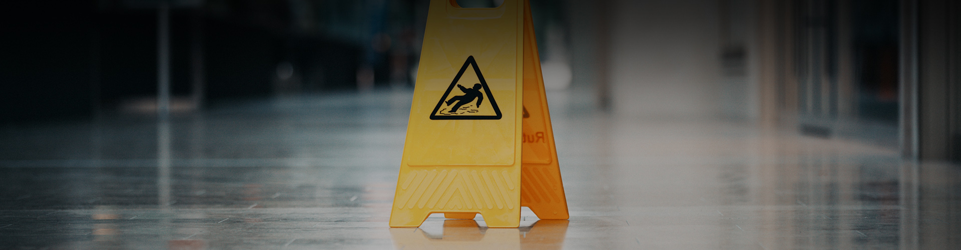 Header photo of a slippery floor warning sign
