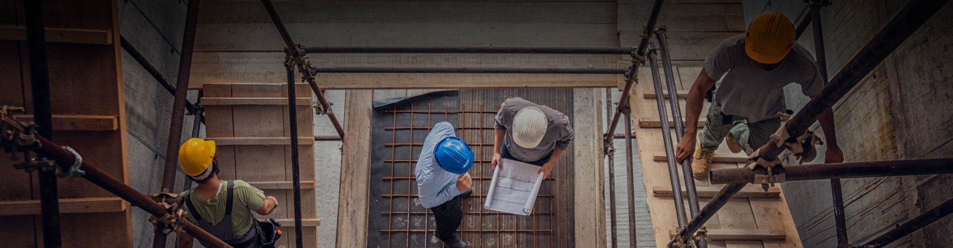 Top down photo of contractor looking at plans