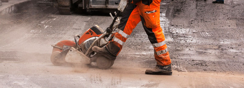 Photo of a construction worker with heavy machinery equipment