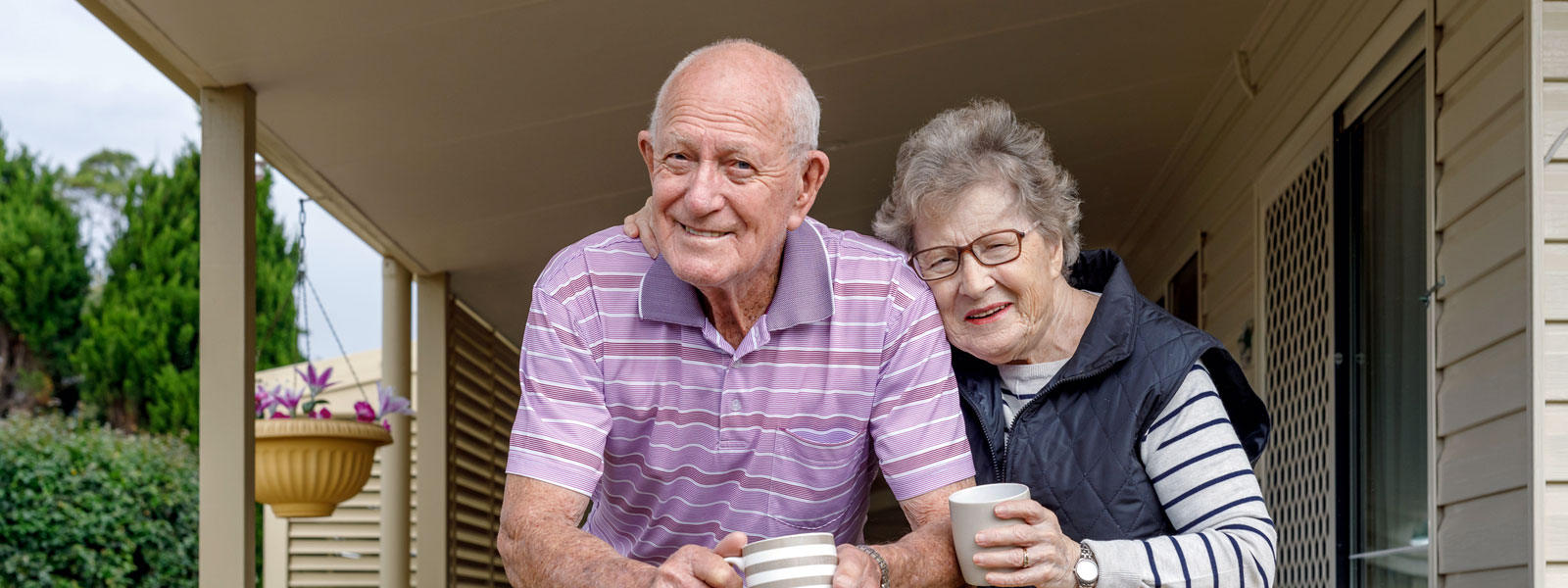 Photo of an elderly couple smiling for the camera