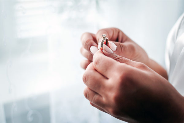 A photo of a man holding an engagement ring