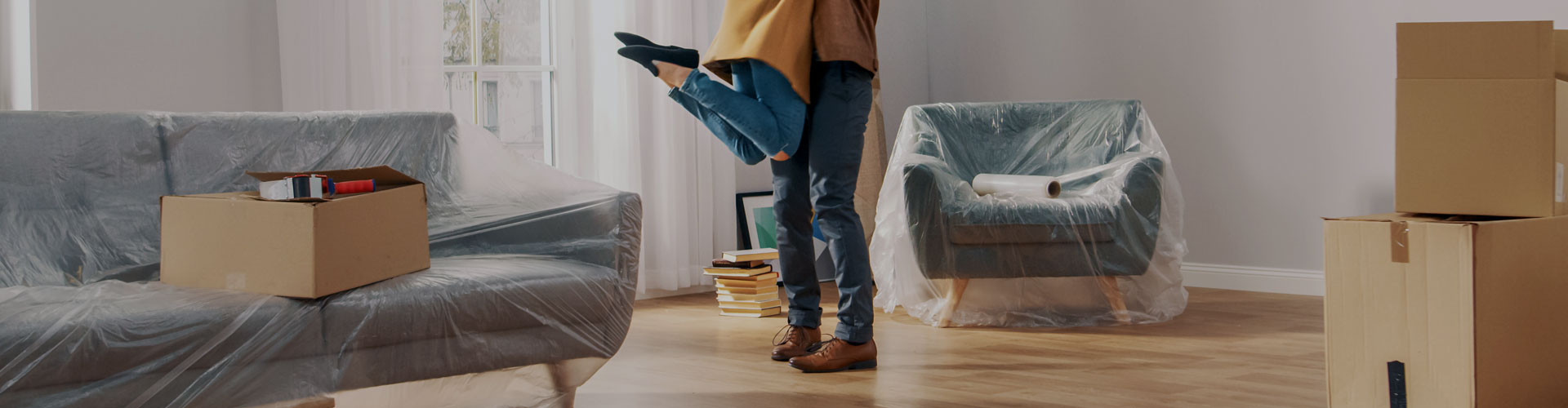 Photo of a happy woman jumping on her husband while being carried