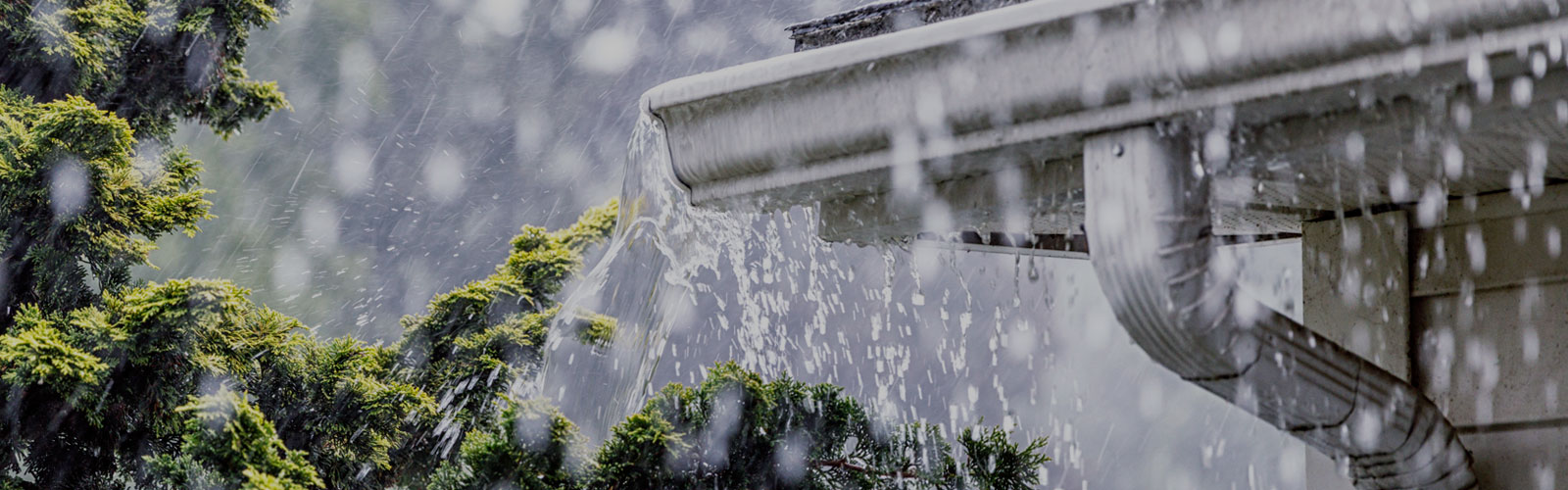 A photo of rain water running off a gutter