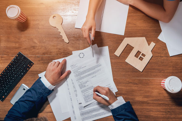 Image of a person signing a new insurance contract