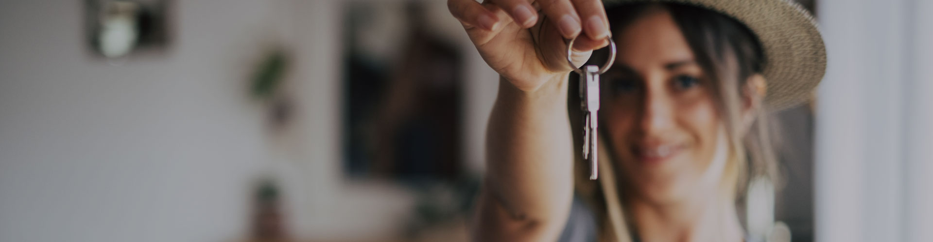Image of a young woman holding house keys