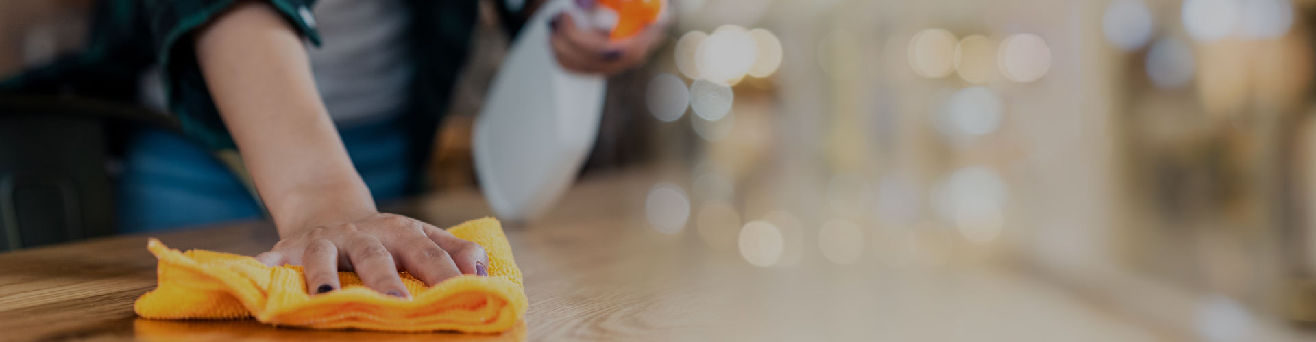 Image of a person wiping a table clean