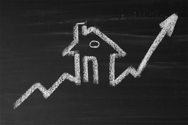 Image of a chalkboard drawing of a house with a graph line