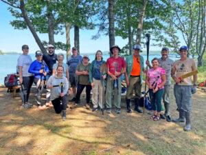 Image of two Clark Insurance employees cleaning hiking trails as volunteers