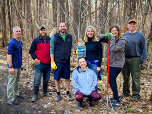 Image of two Clark Insurance employees cleaning hiking trails as volunteers