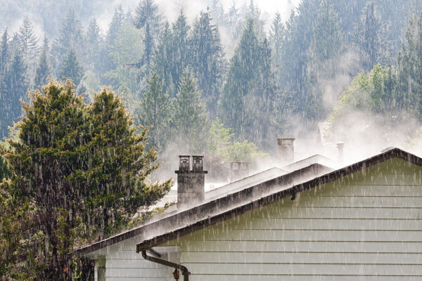 Photo of rain coming down on a roof