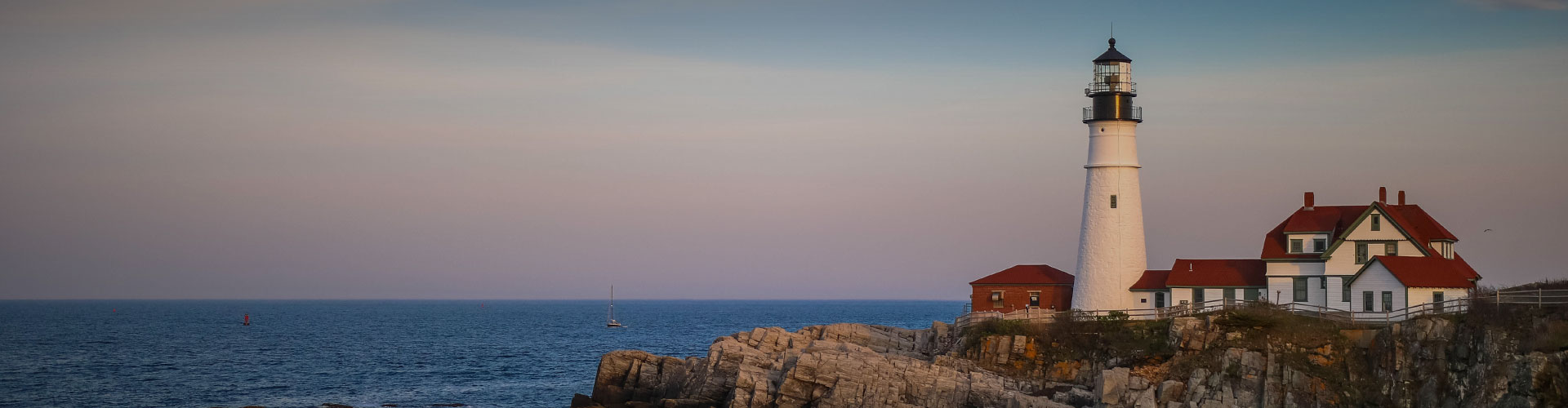 Decorative photo of a lighthouse on a cliff overlooking the ocean