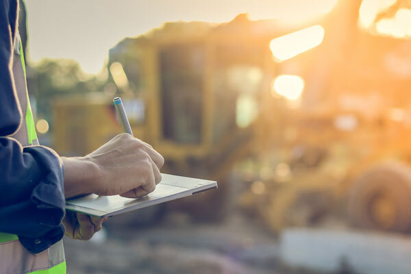 Photo of a construction worker using a tablet at a construction site